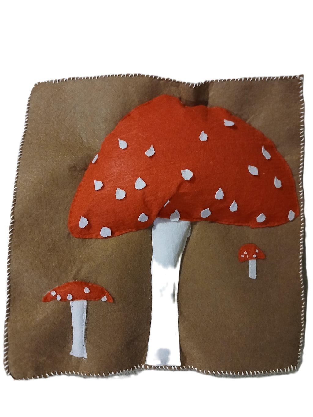 Brown fabric with red mushroom design on a white background